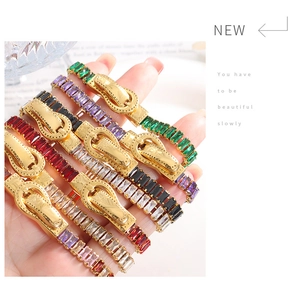 Close-up of luxury gold bracelet featuring multi-colored cubic zirconia and magnetic clasp