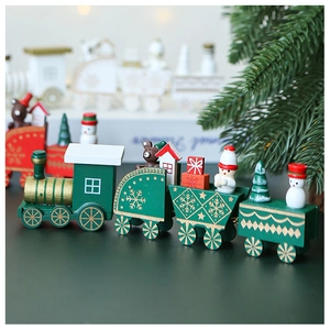 Detail of wooden Christmas train with snowman and bear miniatures in forest green
