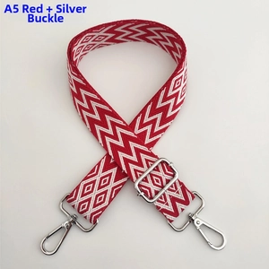 Detail of red and white chevron woven bag strap with silver metal swivel hooks