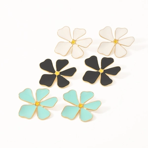 Three pairs of floral stainless steel earrings in white, black, and mint green with gold trim