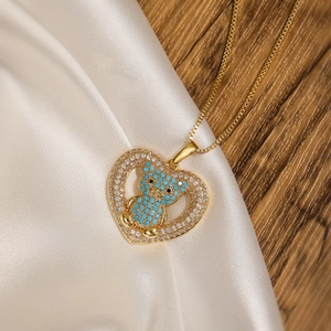 18K gold plated heart bear pendant necklace on white silk and wood background