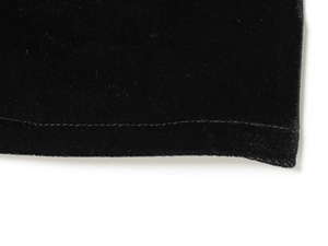 Détail macro de la texture du tissu en velours noir et coutures fines sur la robe