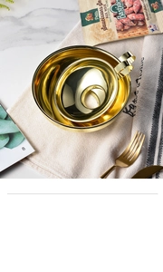 Close-up of dual gold stainless steel canning funnels with handles on linen napkin