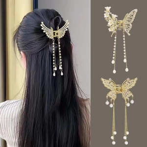 Elegant gold butterfly hair claw clip with rhinestones and long pearl tassel pendant