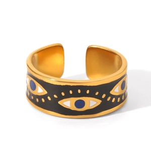 Detailed close-up of adjustable golden stainless steel ring with black evil eye enamel inlay