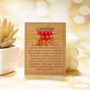 Three-piece red carnelian beaded bracelets with natural stones on a display card