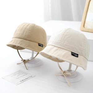 Close-up of cotton baby sun hats with chin straps and woven logo label detail
