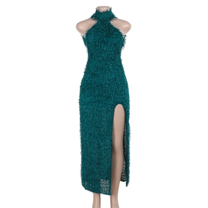 Close-up detail of dark green halter dress with faux feather texture and high side slit