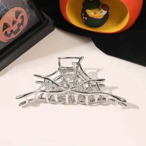 Silver spider web hair claw clip with pumpkins and Halloween themed decorations