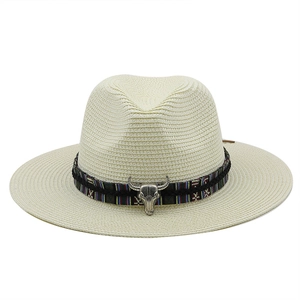 Detail of western straw hat with ethnic band and metal bull head buckle ornament
