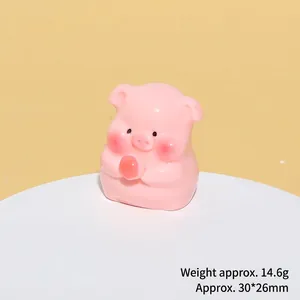 Macro view of cute pink resin pig figurine holding a peach, size 30x26mm and 14.6g