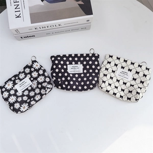 Close-up of corduroy storage pouches with daisy, polka dot, and bow patterns
