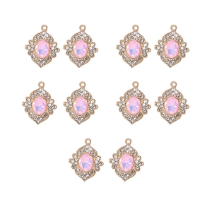 Close-up of 10 golden pink crystal pendants with rhinestone halo for jewelry making
