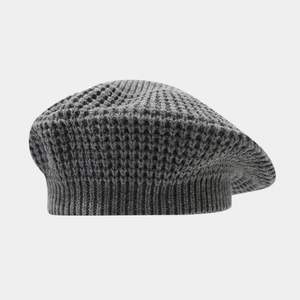 Detailed view of dark grey waffle knit beret showing thick wool texture and ribbed edge