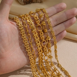 Detail of assorted heavy duty gold geometric heart knot woven chain necklaces