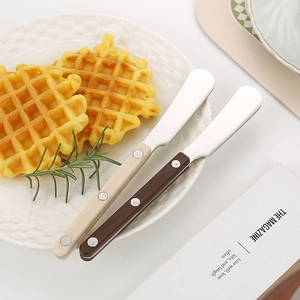 304 stainless steel butter spreader with rivet handle on elegant waffle plate