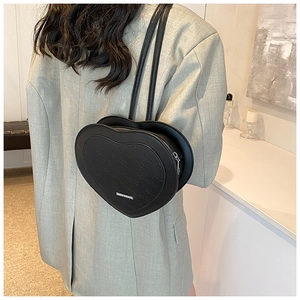 Close-up of heart-shaped black PU leather backpack with letter embossing and silver metal detail