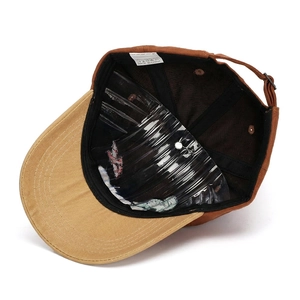 Internal detail of two-tone cotton baseball cap with metal buckle and inner support