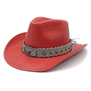 Red western straw cowboy hat with a metal bull head buckle and curved brim on white background