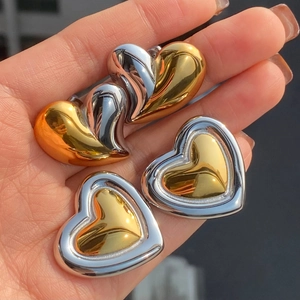 Two pairs of heart-shaped stainless steel earrings in gold and silver metallic tones