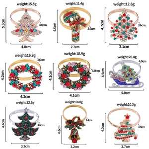 Grid view of vintage Christmas napkin rings with colorful zircons in tree and sled shapes