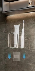 Macro detail of wall-mounted toothbrush holder with soap dish on dark marble wall