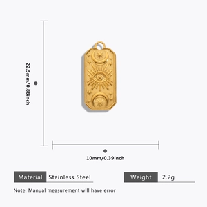 Detail view of gold rectangle pendant with celestial engraving and size measurements
