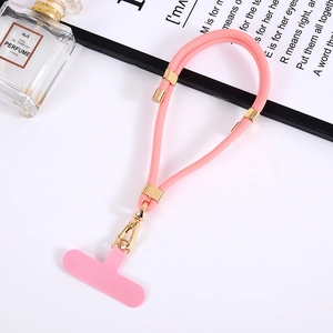 Detailed view of pink woven phone lanyard with gold metal buckle and T-shaped insert