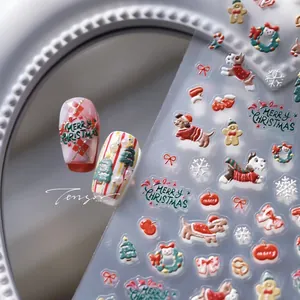 Macro detail of 3D embossed Christmas nail stickers with cute dogs and holiday motifs