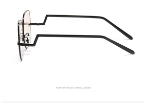 Detail view of black metal pilot sunglasses with unique stepped temple design and light lenses