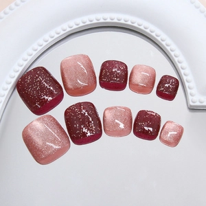Faux ongles d'orteils élégants rouge vin et nude avec effet œil de chat et paillettes