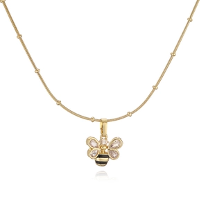 Detailed macro view of bee pendant with zircon wings and black enamel on beaded chain