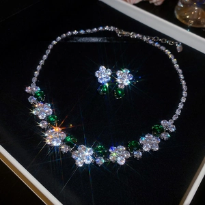Luxurious flower jewelry set with green zircon stones presented in a premium black velvet box