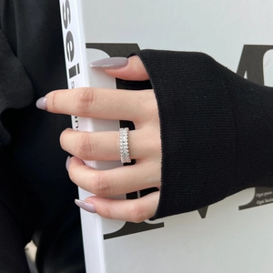 Macro detail of S925 silver eternity ring featuring triple rows of baguette-cut zircon