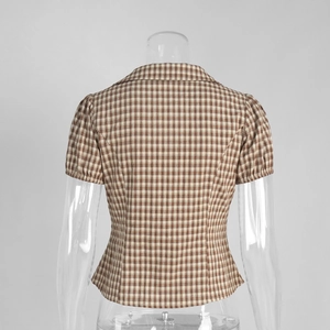 Detailed back view of brown plaid slim-fit shirt featuring a cinched waist and pleated details