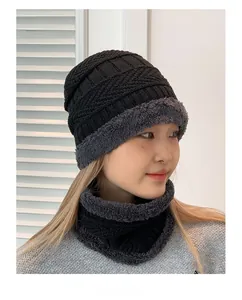 Close-up of black cable knit beanie and neck warmer with thick grey fleece lining