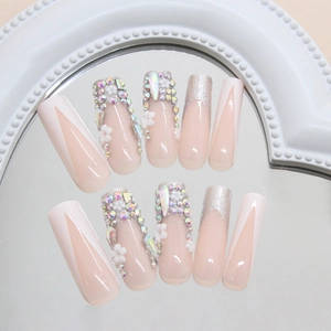 Sparkly floral press-on nails with 3D flowers and colorful rhinestones on mirror surface