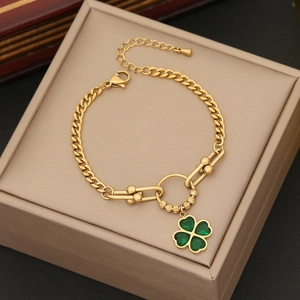 Elegant gold stainless steel link bracelet featuring a vibrant green clover pendant