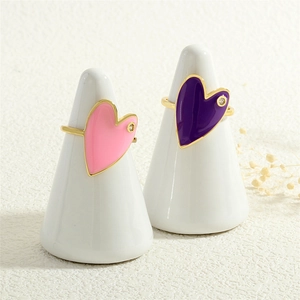 Minimalist gold rings with pink and purple heart-shaped accents and small diamonds
