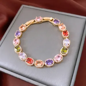 Vintage gold bracelet with oval colorful gemstones and sparkling zircon halo settings