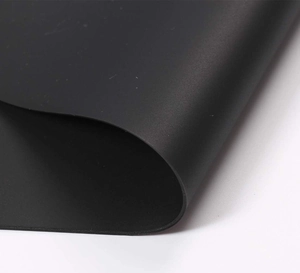 Macro shot of 70x50cm matte black silicone mat edge showing thickness and soft texture