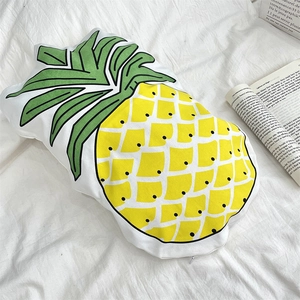 Detail of pineapple shaped cushion cover with black dots and hidden zipper on bed