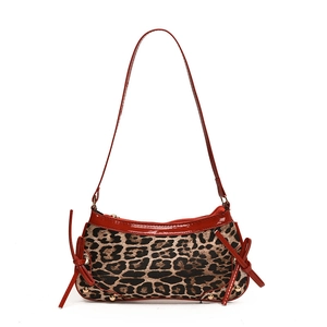Leopard print handbag with red patent leather trim, bow details and metal studs
