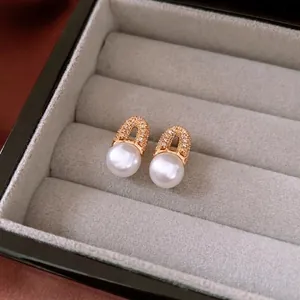 Elegant 18K gold plated pearl geometric drop earrings showcased in a velvet jewelry box