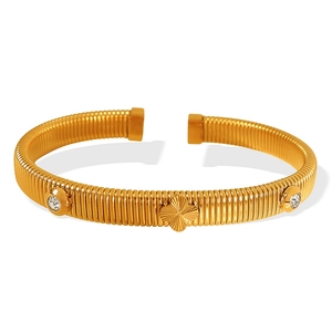 Elegant 18k gold plated clover snake bone bangle with white rhinestones on white background