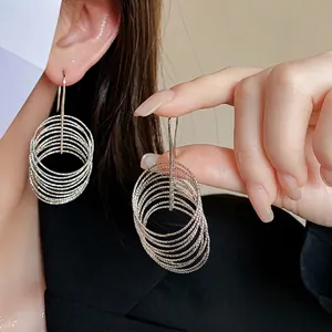 Luxurious silver layered circular hoop drop earrings with multiple concentric ring design