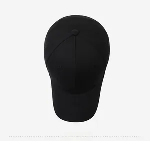 Top view of a black cotton twill baseball cap showing six-panel stitching and top button