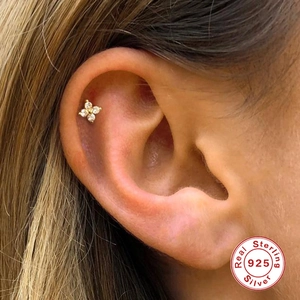Detail of 925 sterling silver gold flower stud earring with sparkling zircon petals