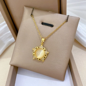 Macro detail of gold star necklace with cat eye stone and sparkling crystals in a box