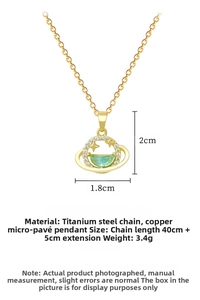 Close-up of gold planet pendant with zircon stones and green crystal on thin chain